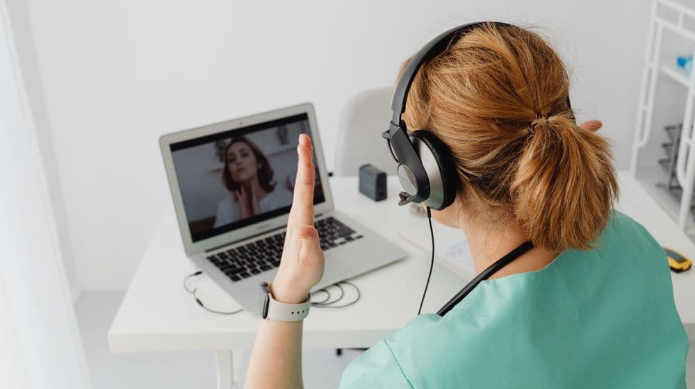 A nurse practitioner meeting with a patient over a telehealth video call
